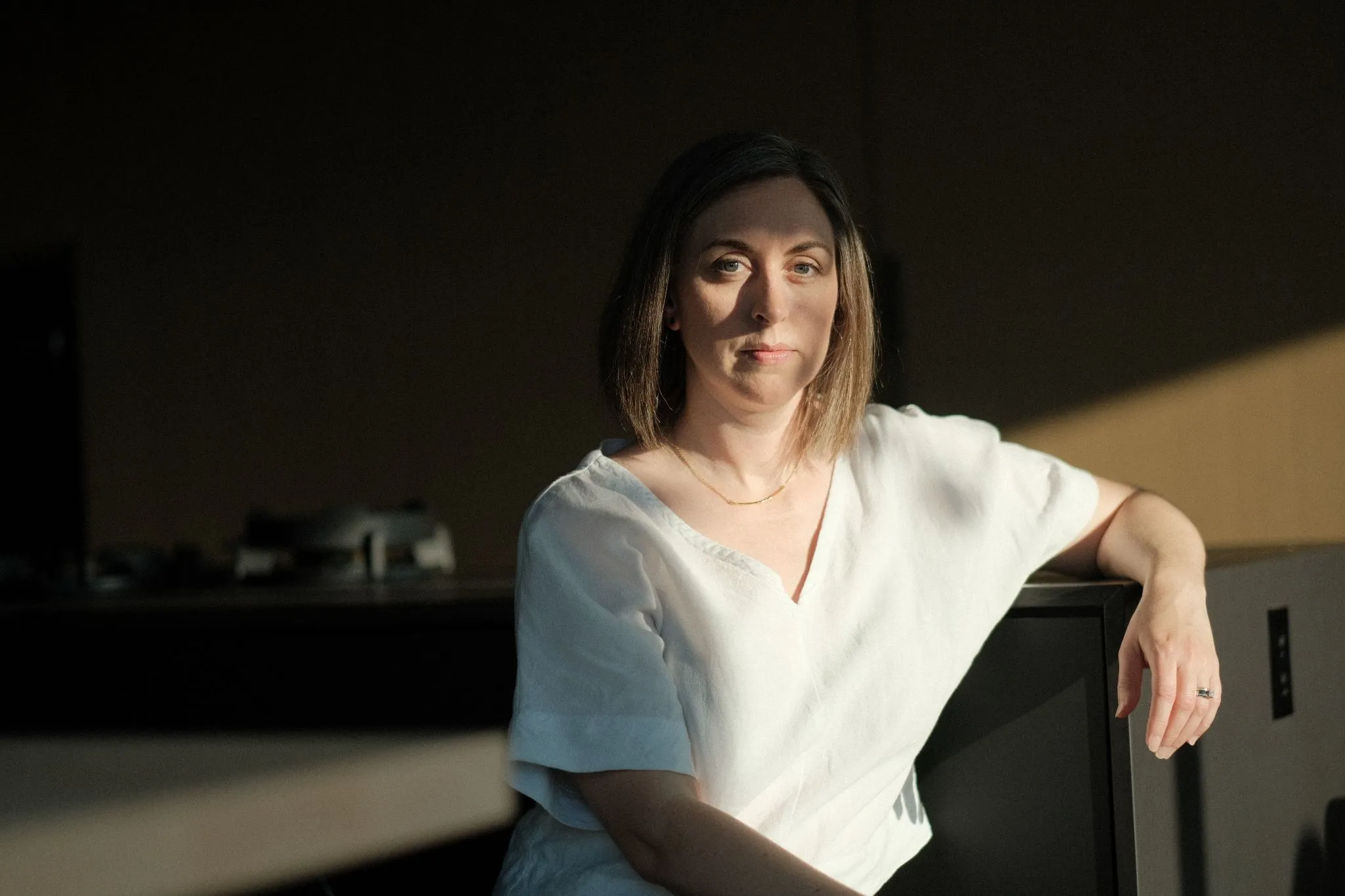Rebecca Sorbara confident portrait seated with arm resting on chair